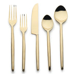 Set of gold cutlery on a white background