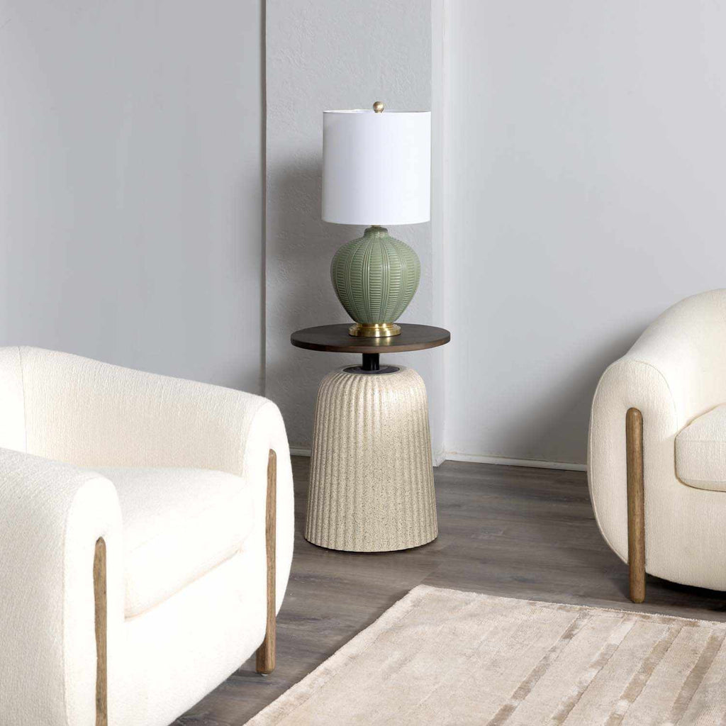Modern living room with a side table, green table lamp, and two chairs.