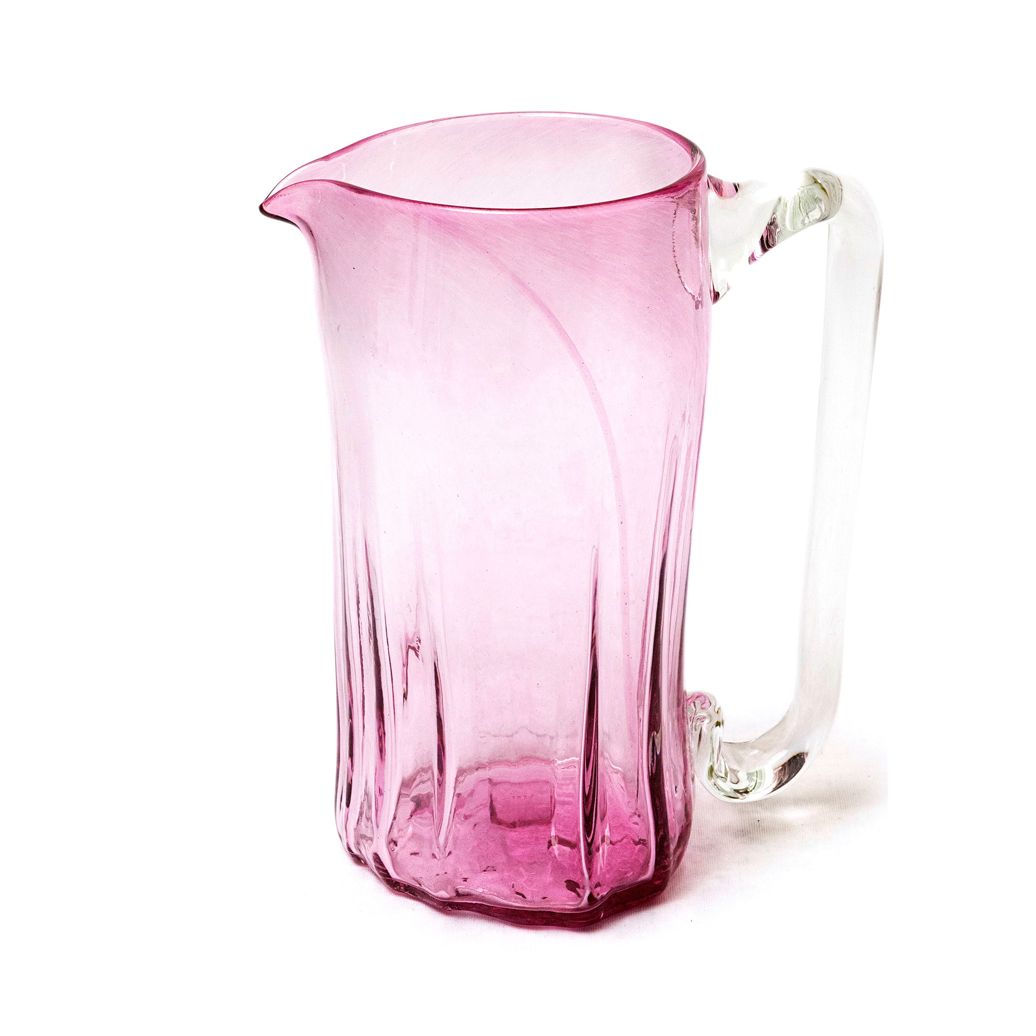 Pink glass pitcher on a white background