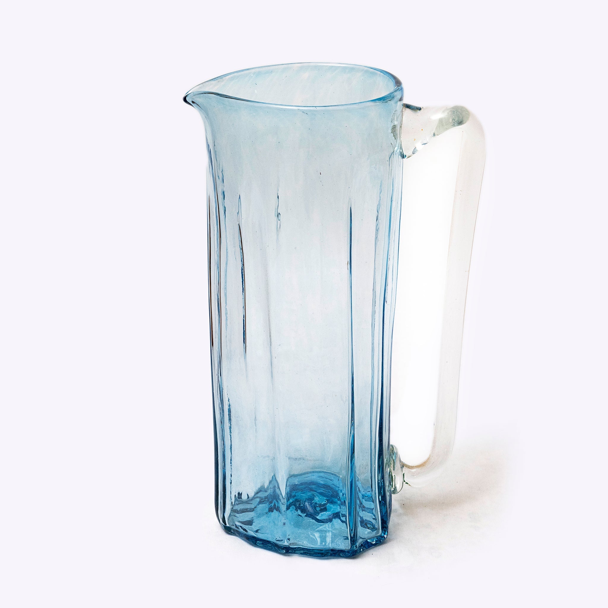 Blue glass pitcher on a white background