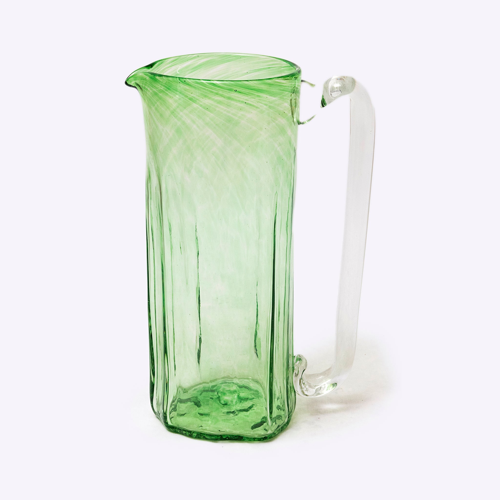 Green glass pitcher on a white background