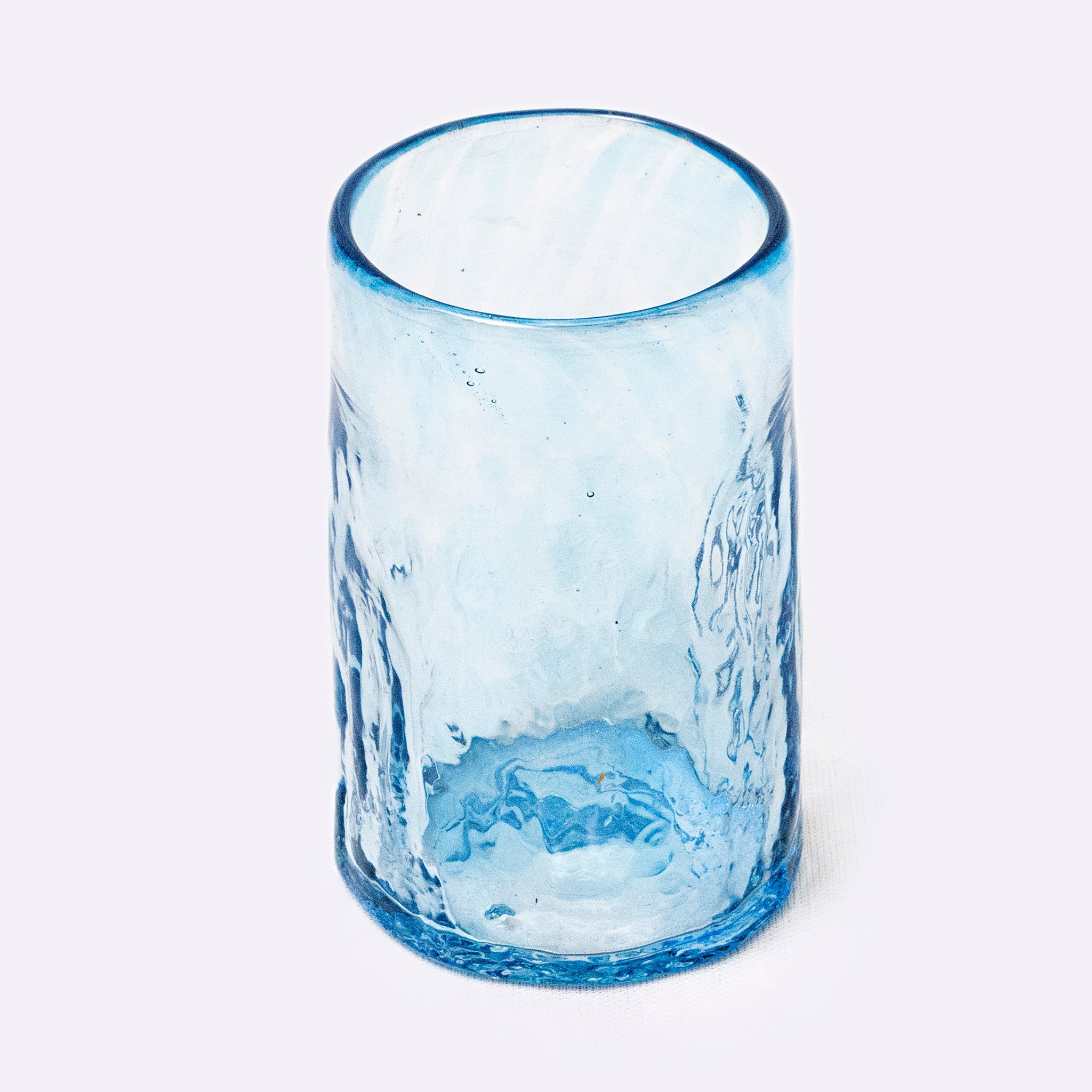 Blue glass tumbler on a white background