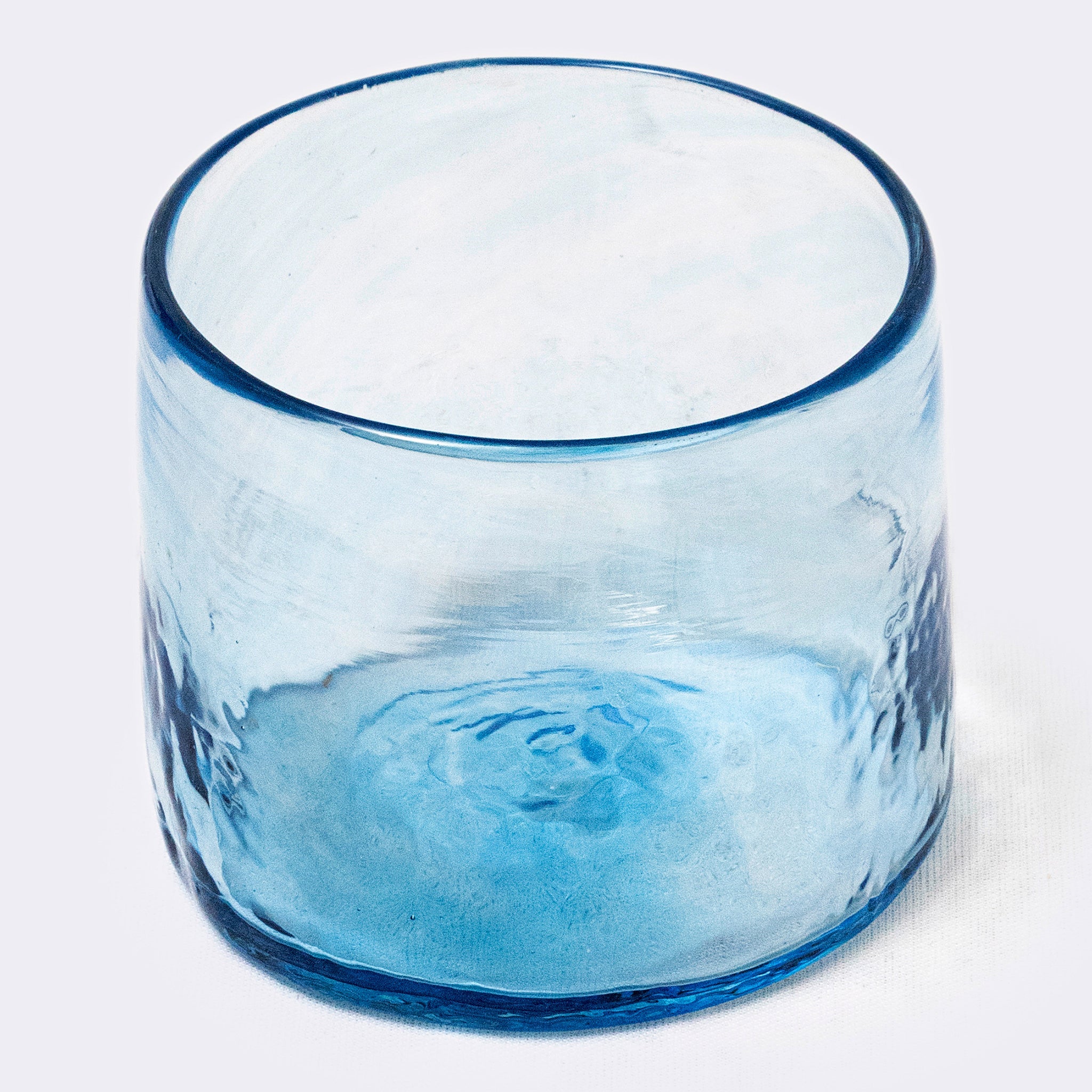 Blue glass tumbler on a white background