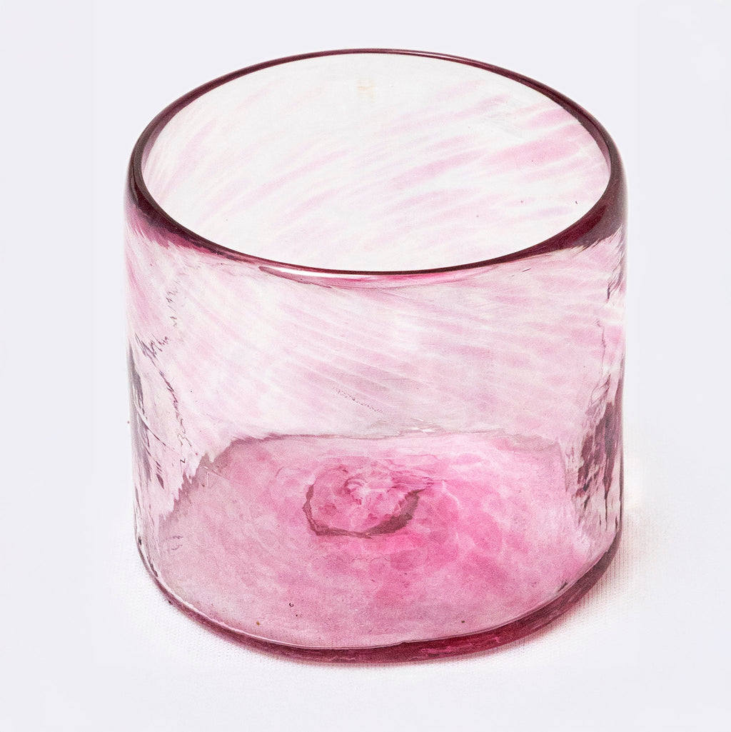 Pink glass candle holder on a white background