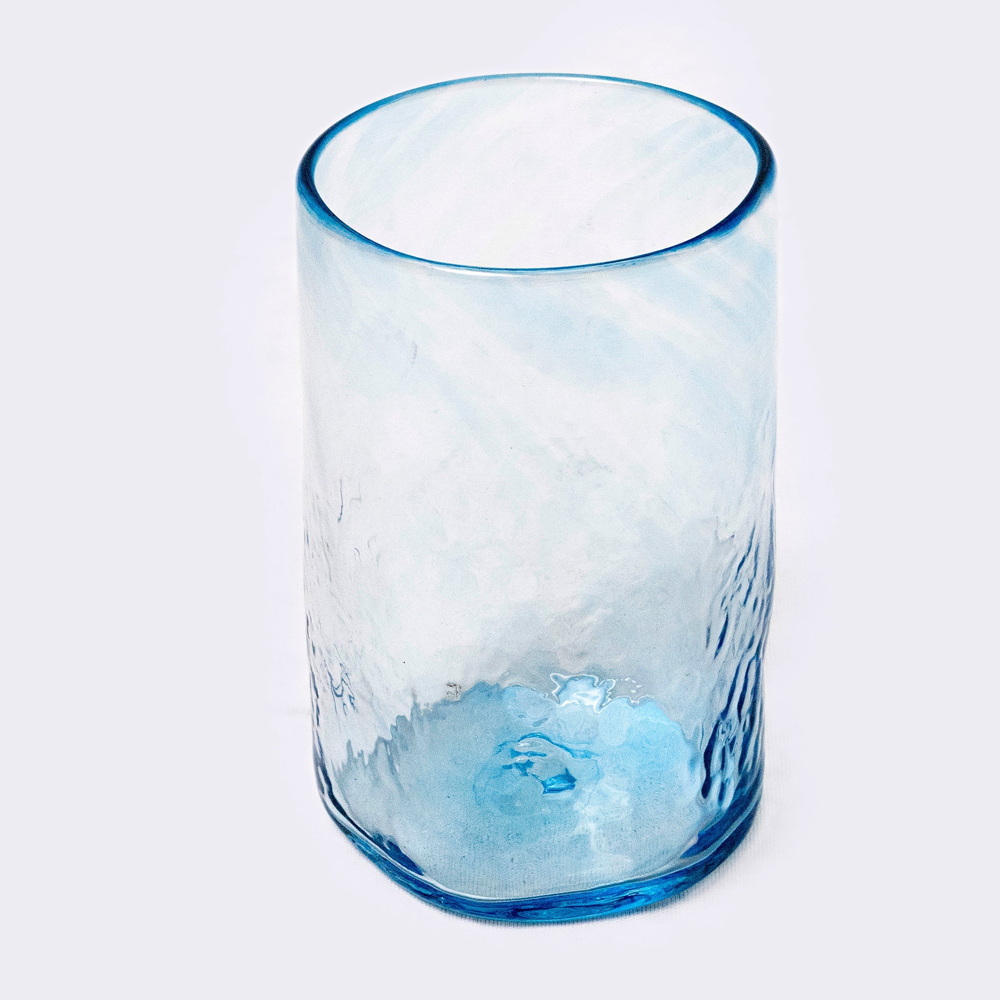 Clear glass with blue rim and base on a white background
