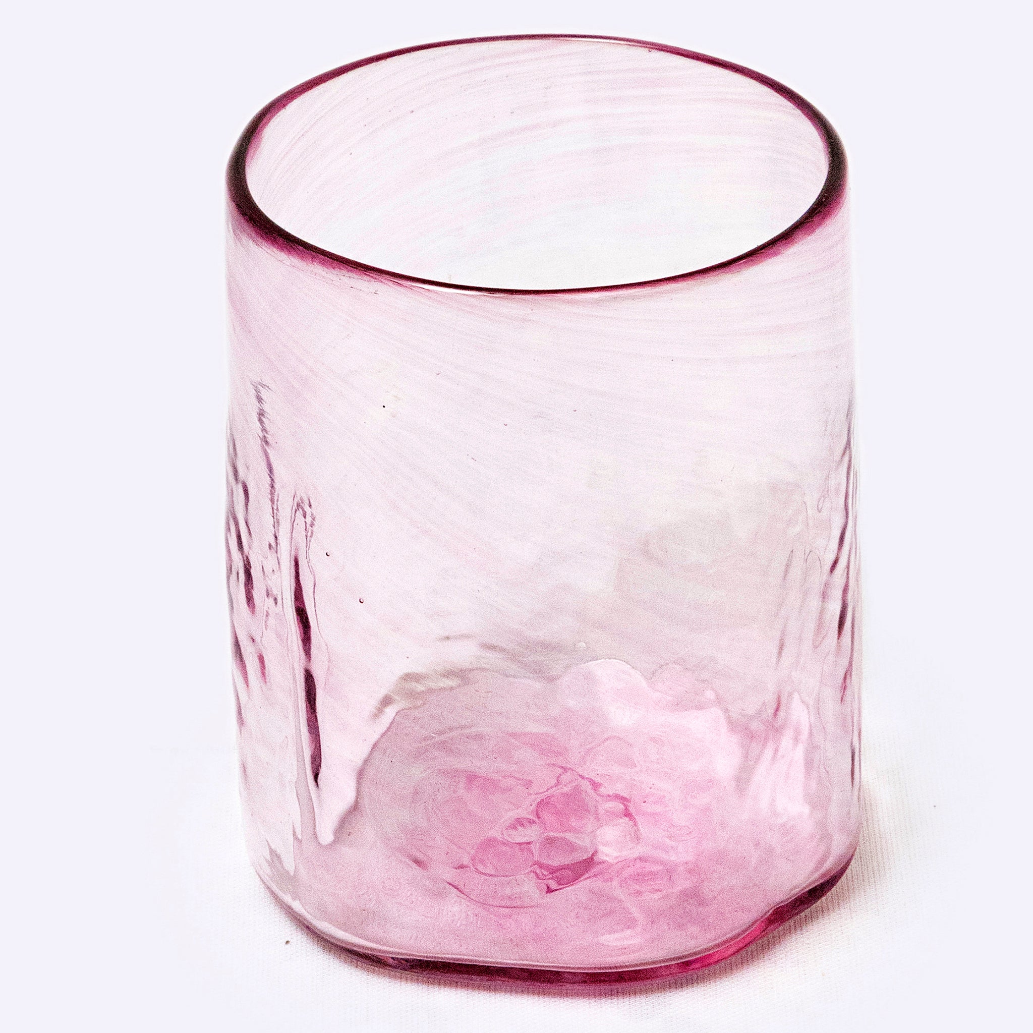 Pink glass tumbler on a white background