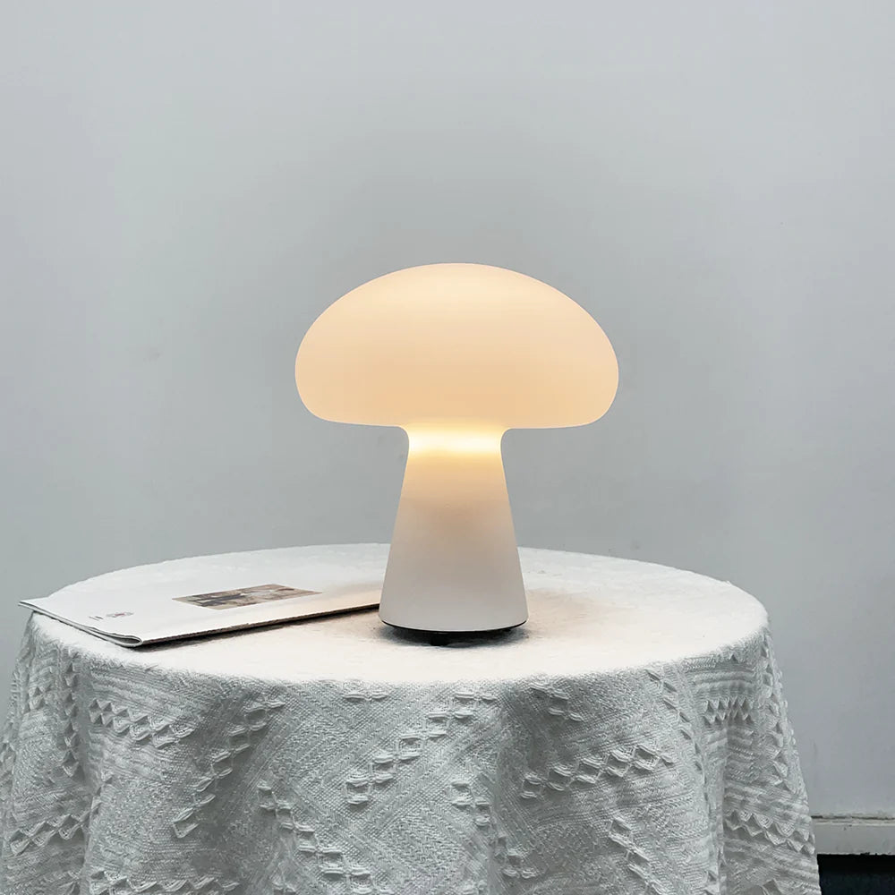 Mushroom-shaped table lamp on a textured surface with a gray background