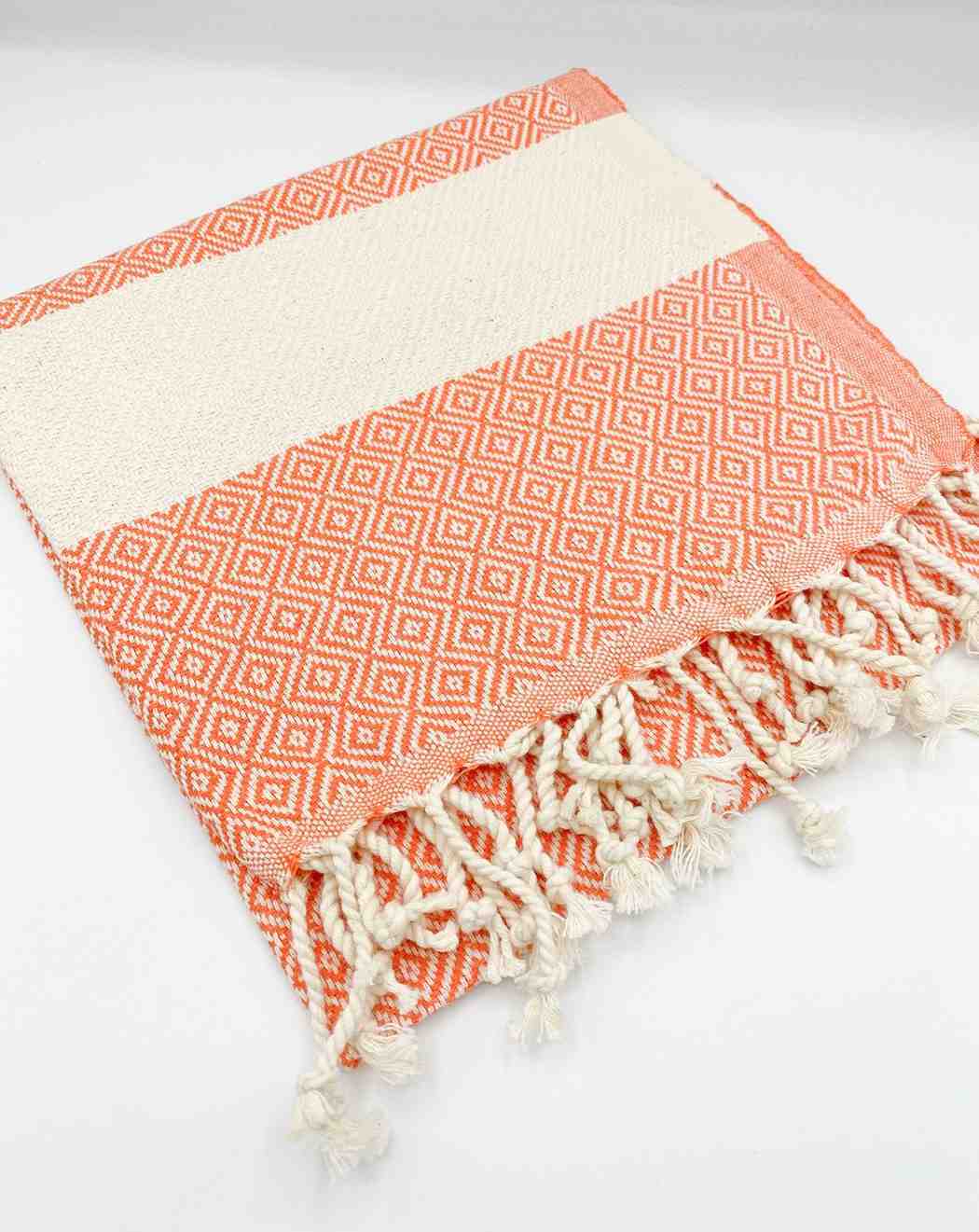 Orange diamond pattern hand towel with cream stripe and twisted fringe on white background
