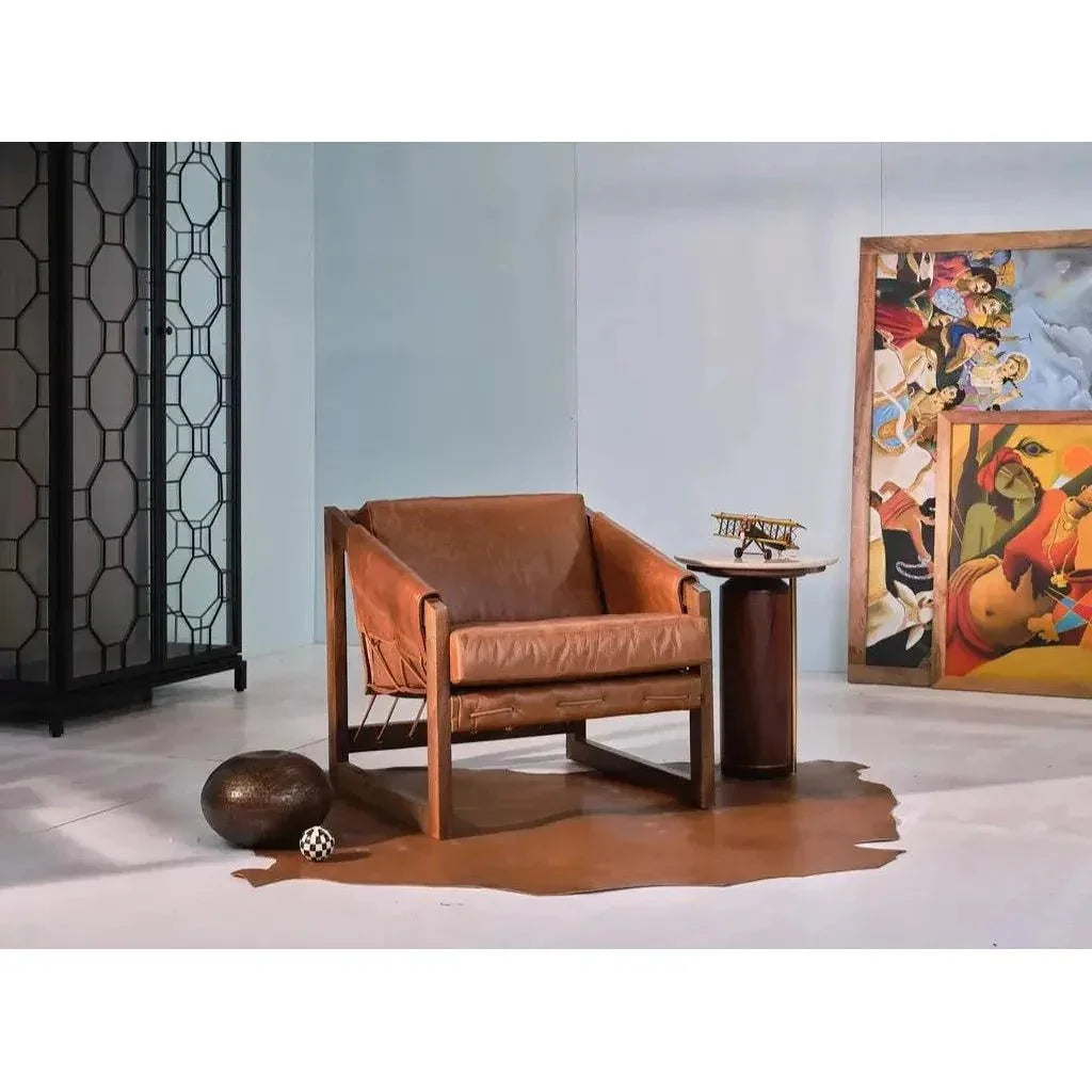 Brown leather armchair in a room with a colorful abstract painting on the wall.