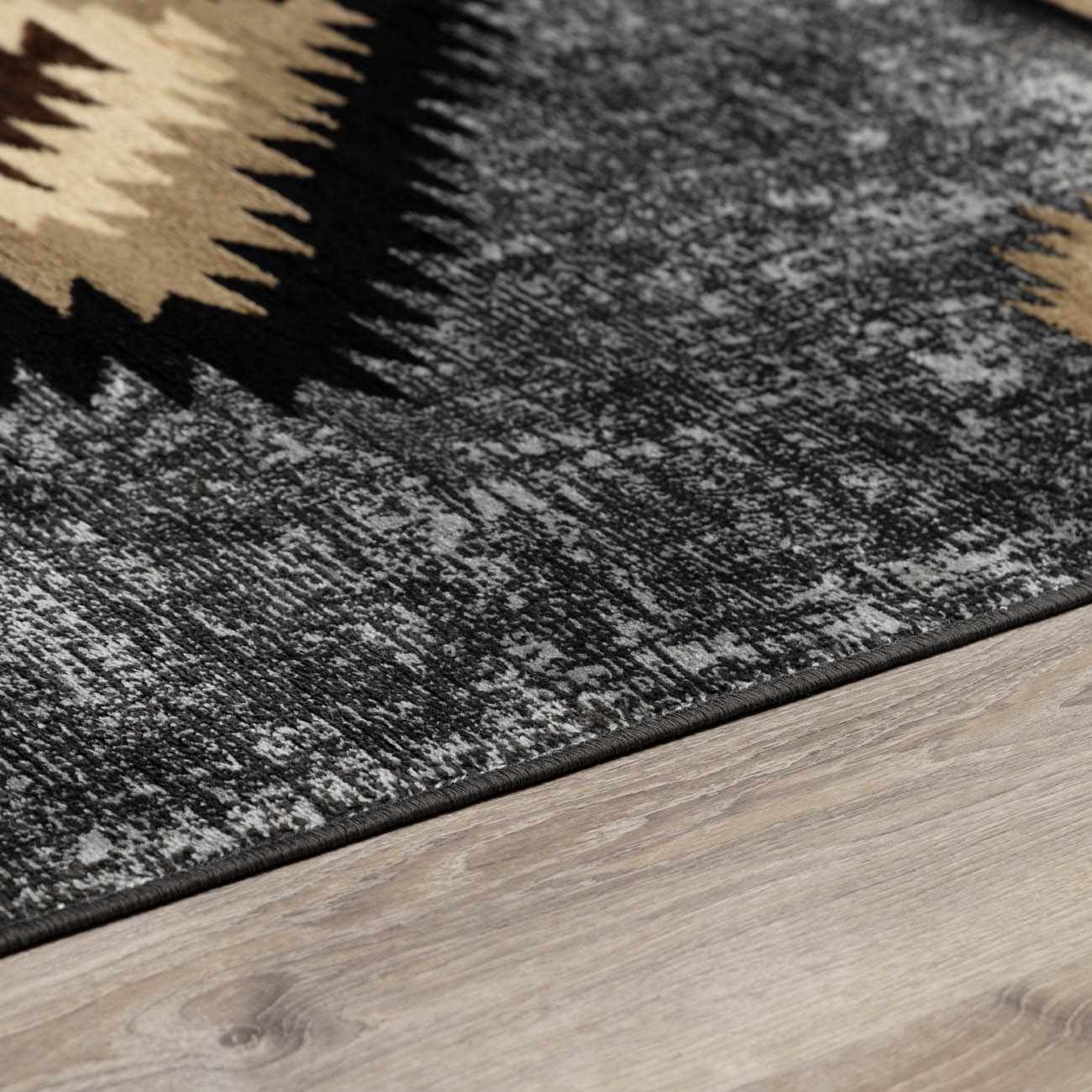 Close-up of a patterned rug on a wooden floor