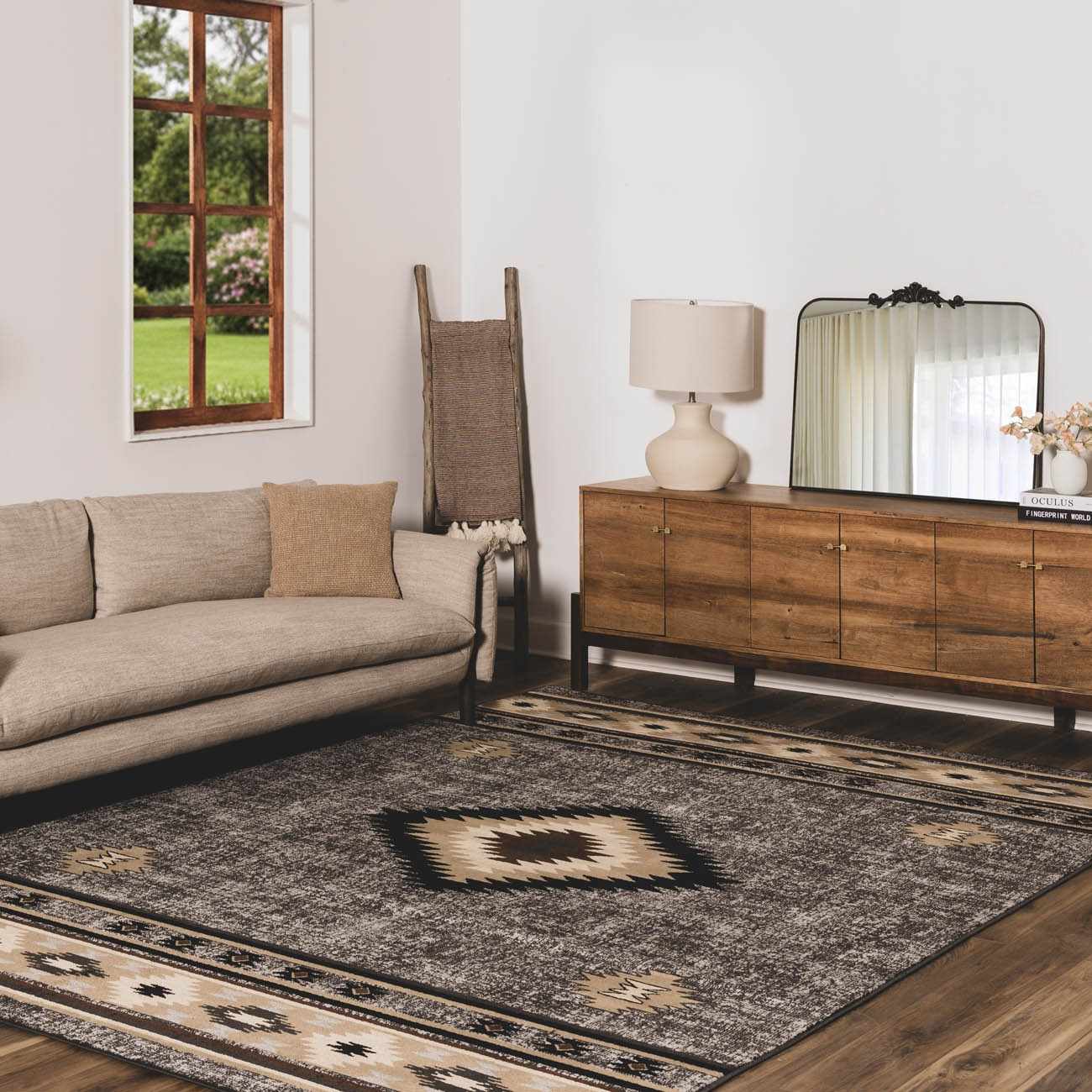 Living room with a beige sofa, wooden sideboard, and decorative rug.