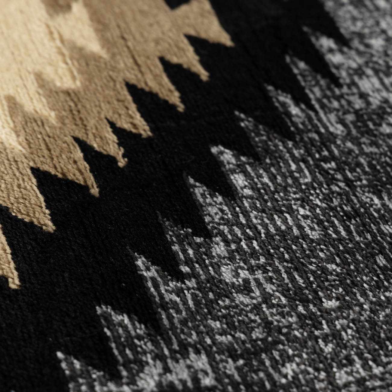 Close-up of a textured rug with geometric pattern