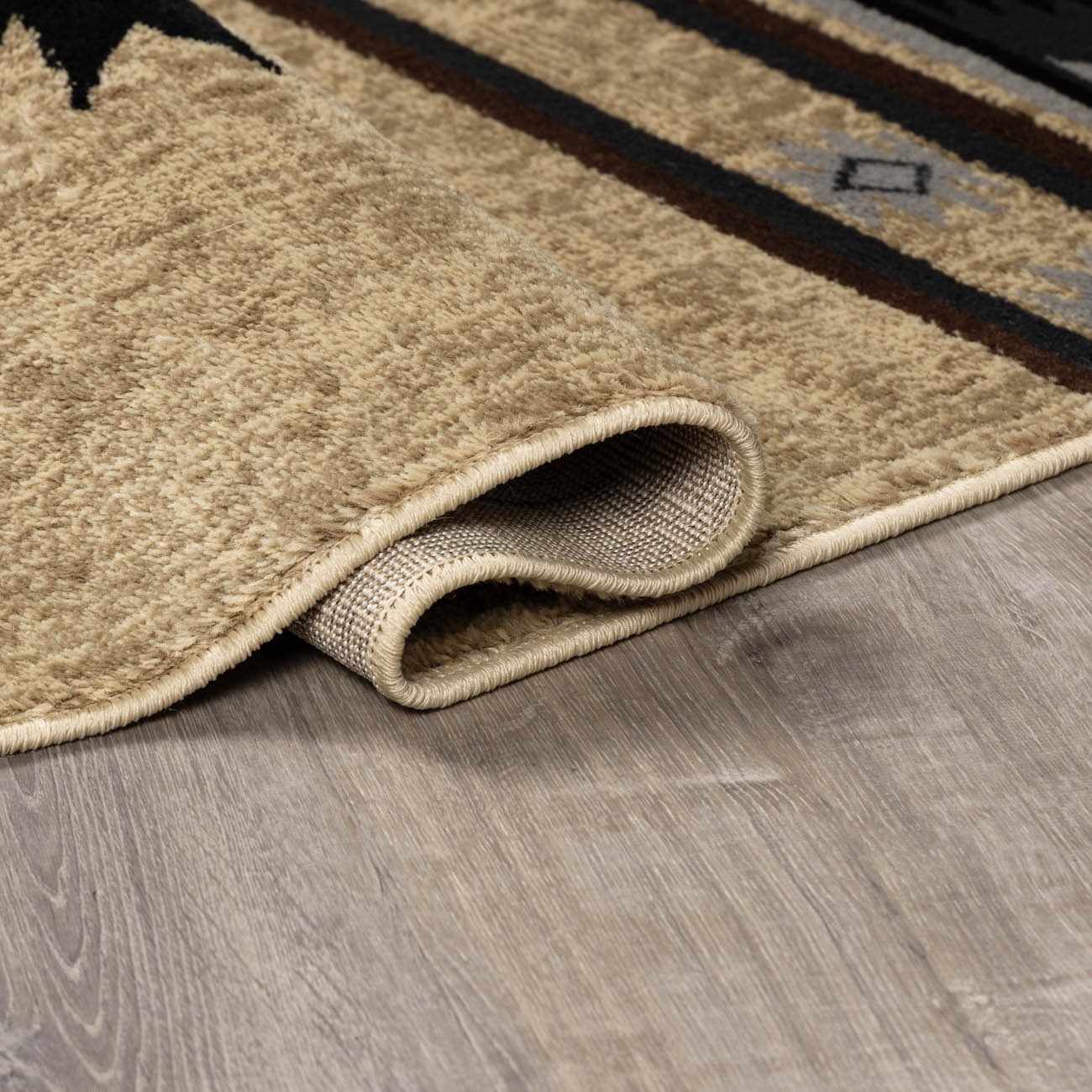 Beige area rug with a textured pattern on a wooden floor