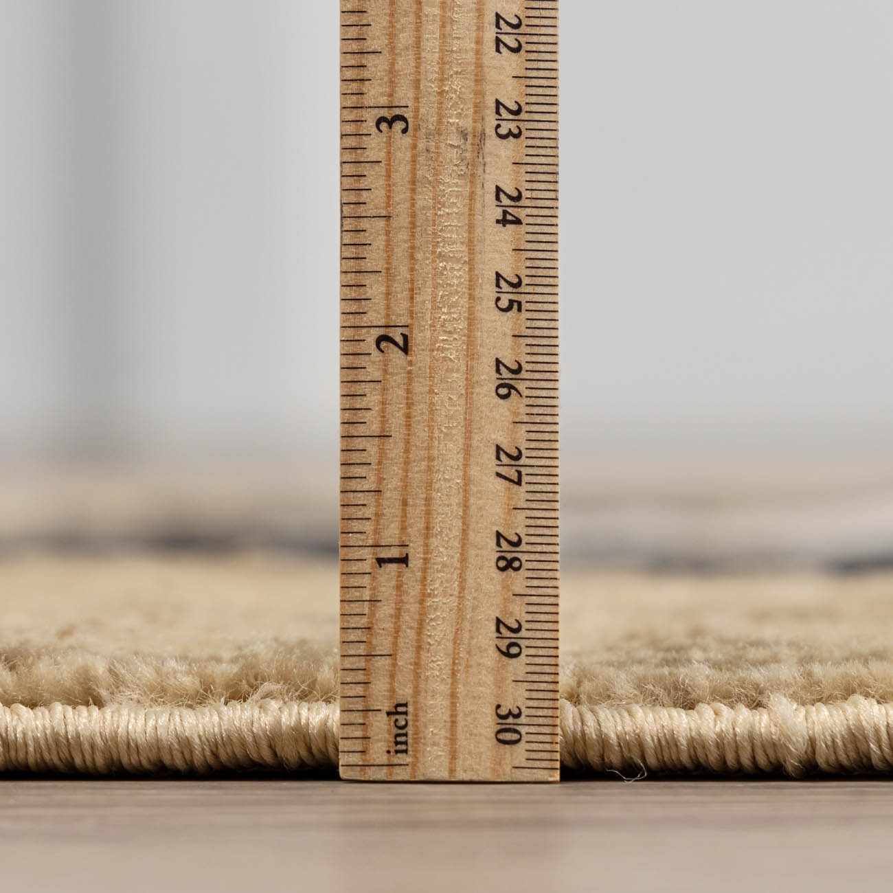 Wooden ruler on a carpet with a blurred background