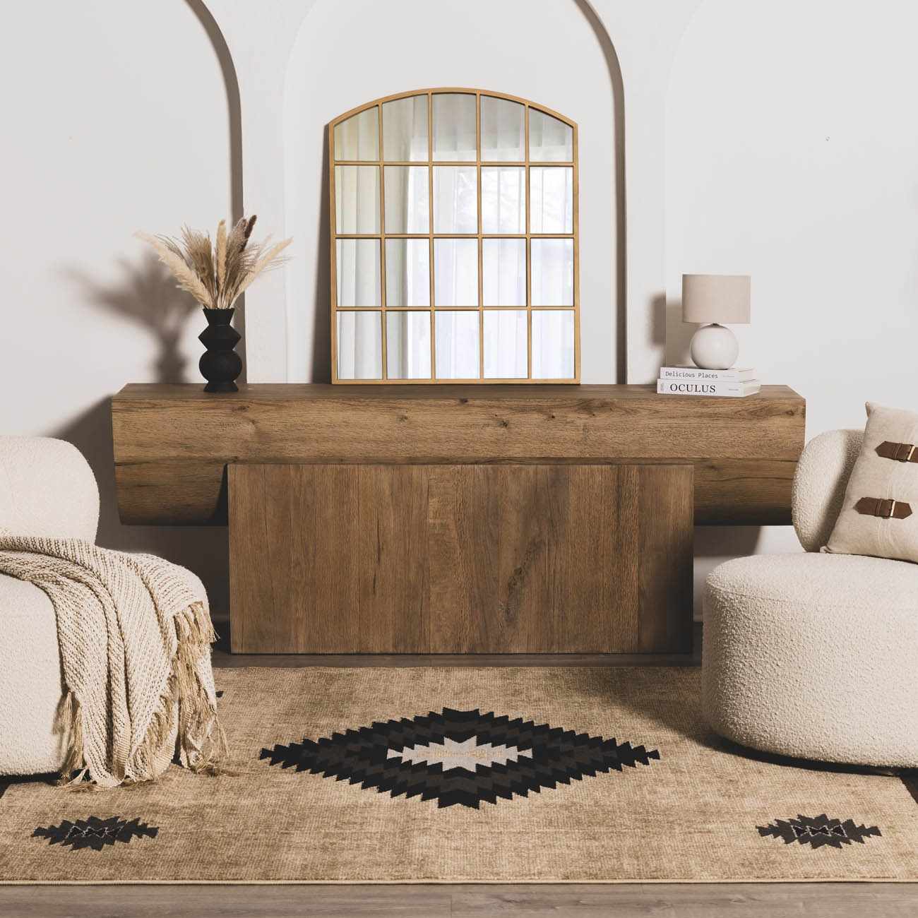 Wooden console table in a living room with a mirror and decor items.
