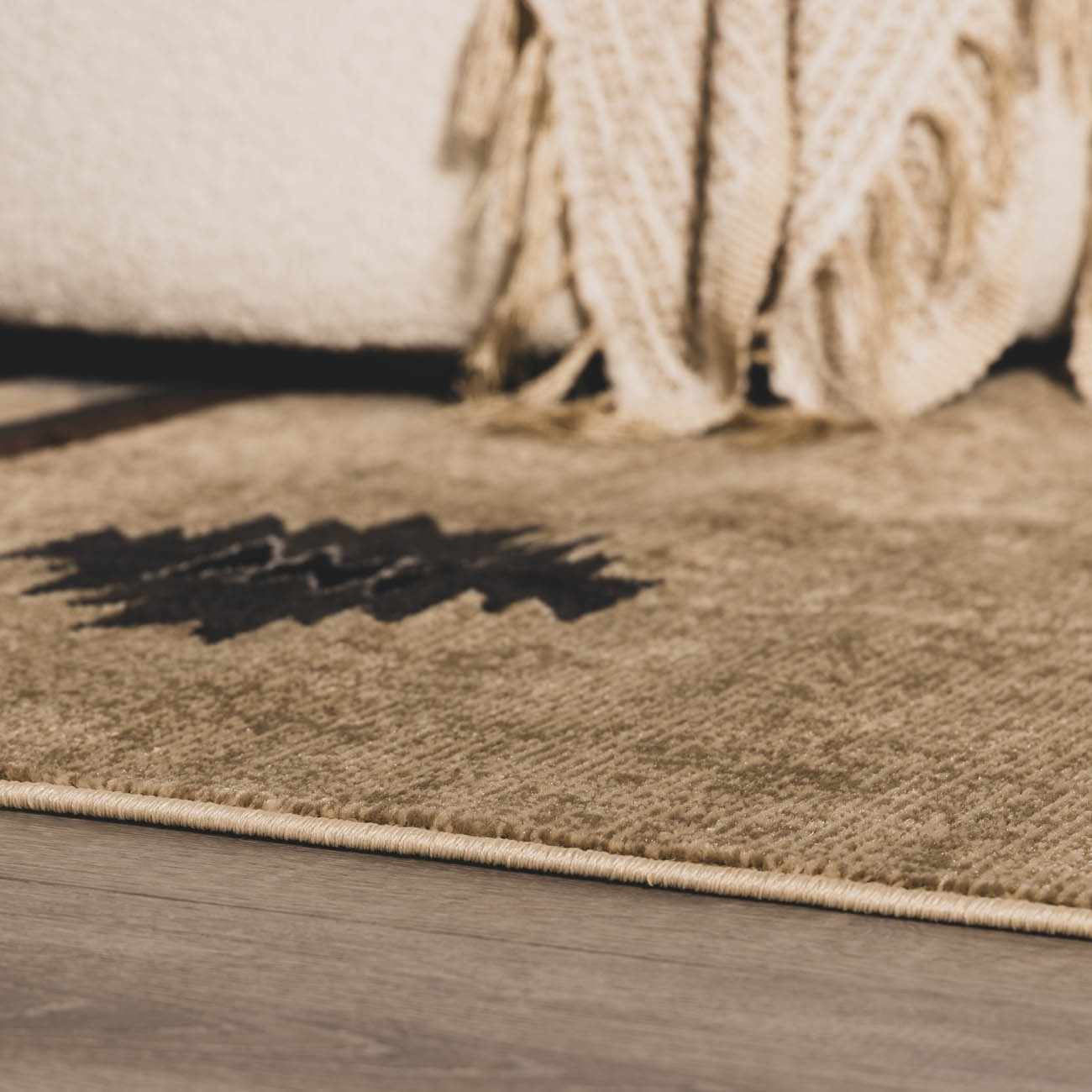 Brown rug on a wooden floor with a textured surface