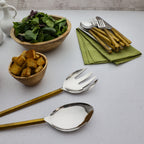 Table setting with salad, croutons, and cutlery on a light surface
