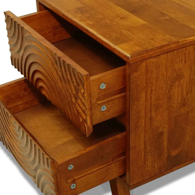 Wooden desk with decorative carvings on drawers and surface