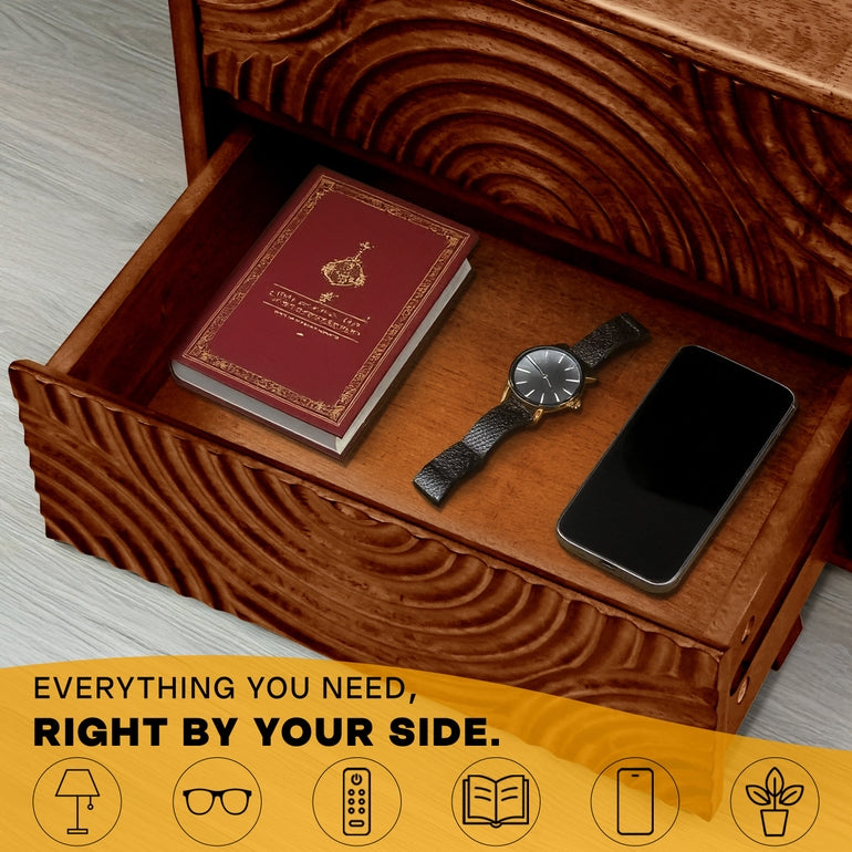 Wooden drawer with a book, watch, and phone on a wooden surface.