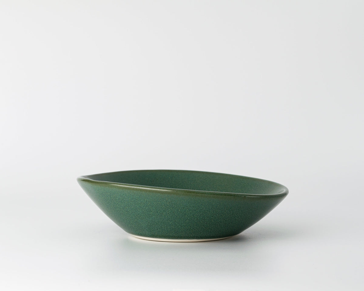 Green ceramic bowl on a white background