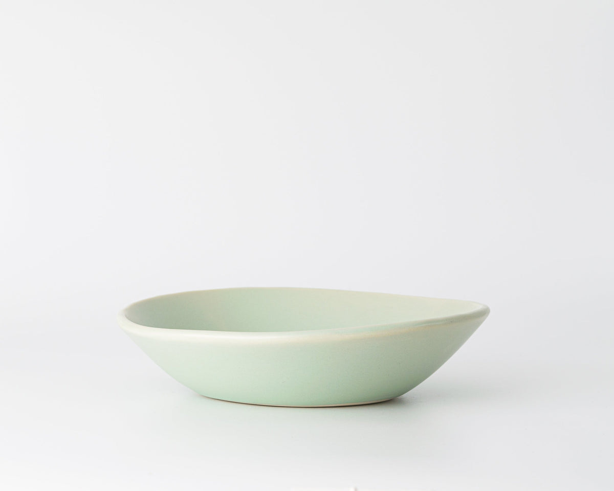 Light green ceramic bowl on a white background