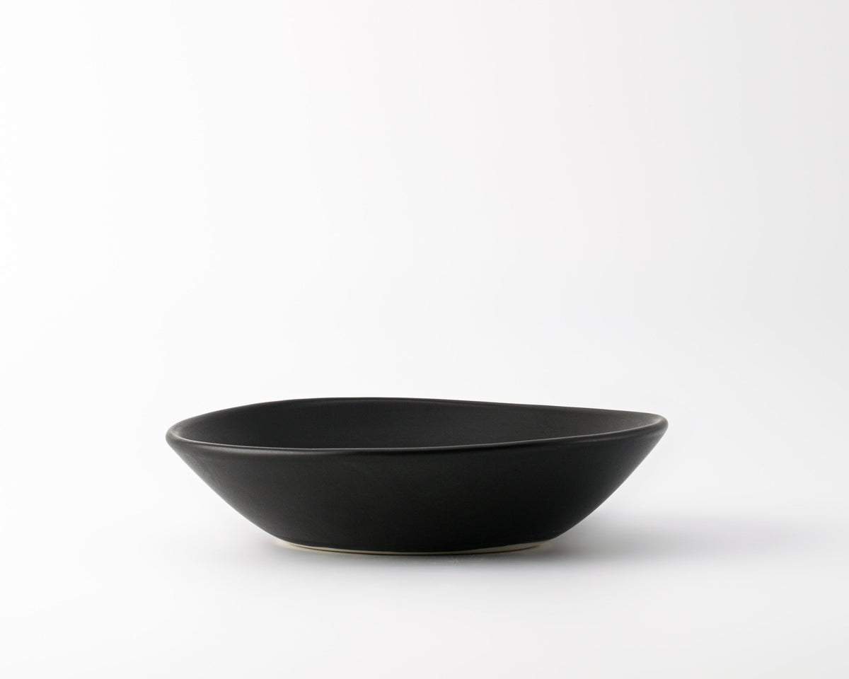 Black ceramic bowl on a white background