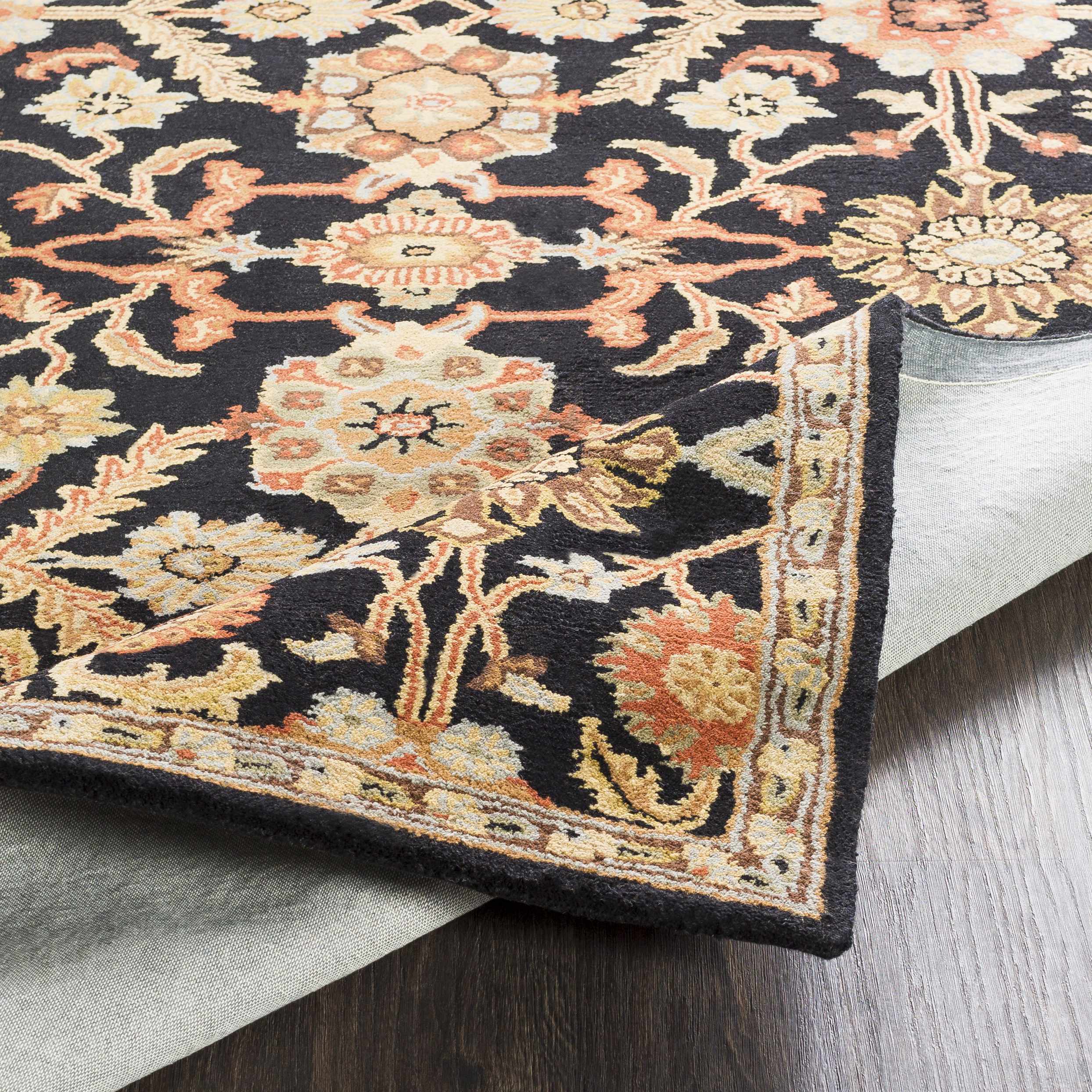 Decorative rug with intricate floral patterns on a wooden floor.