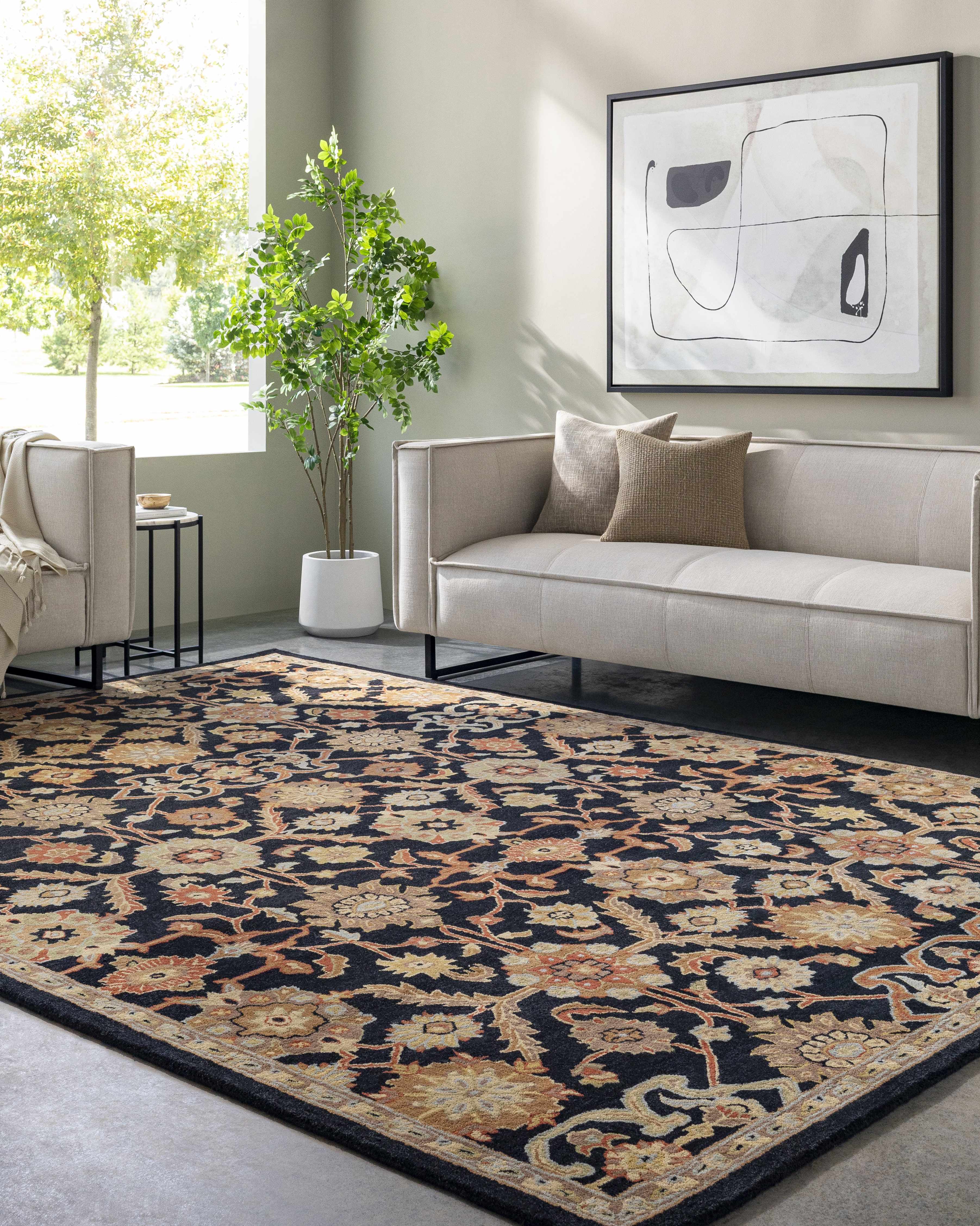 Living room with a patterned rug, sofa, and abstract art on the wall.