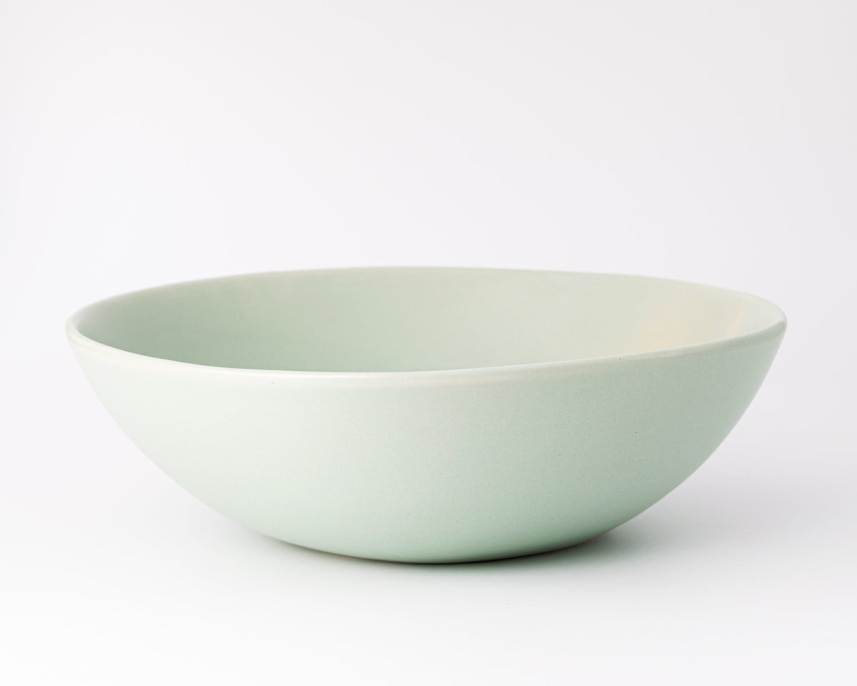 Light green ceramic bowl on a white background