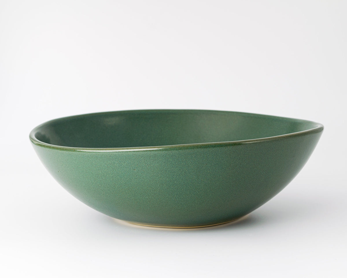 Green ceramic bowl on a white background