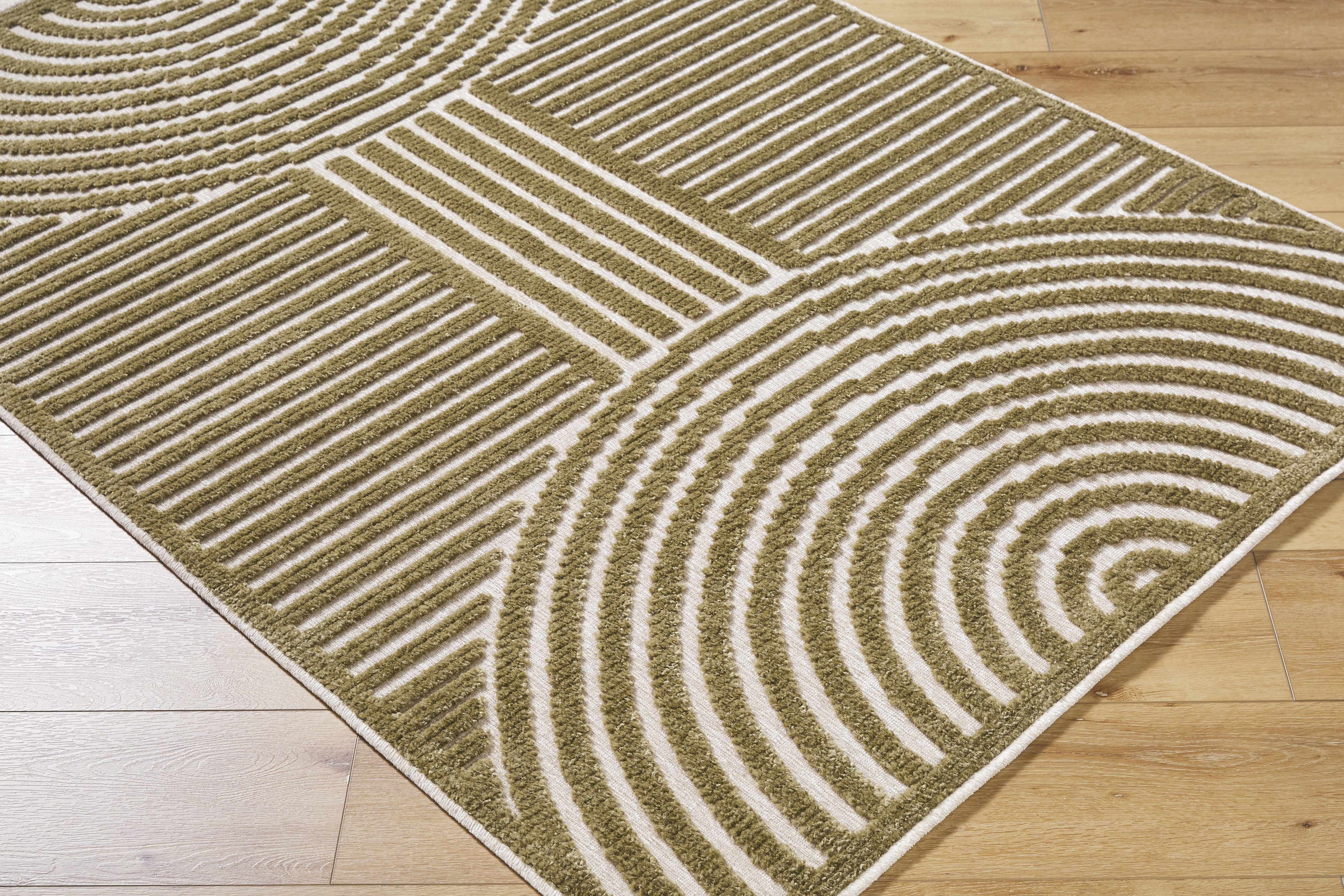 Textured green rug with circular pattern on a wooden floor