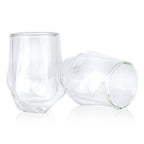 Two clear glass tumblers on a white background