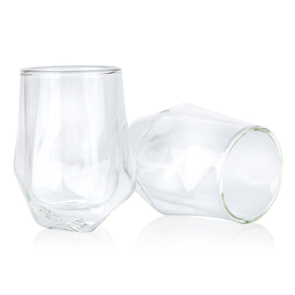 Two clear glass tumblers on a white background