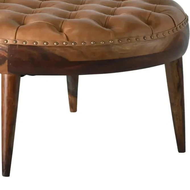 Brown leather ottoman with studded details on a white background
