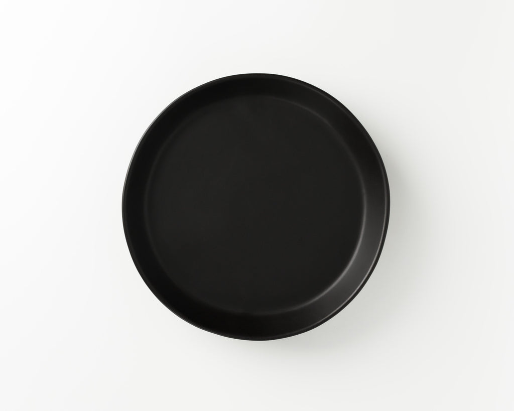 Black round plate on a white background