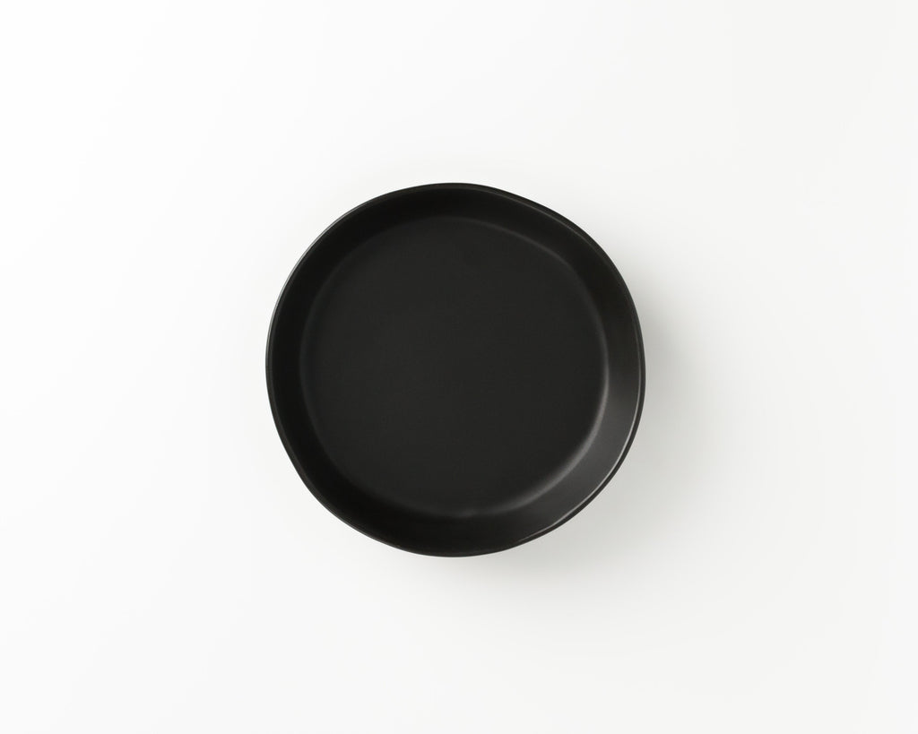 Black round plate on a white background