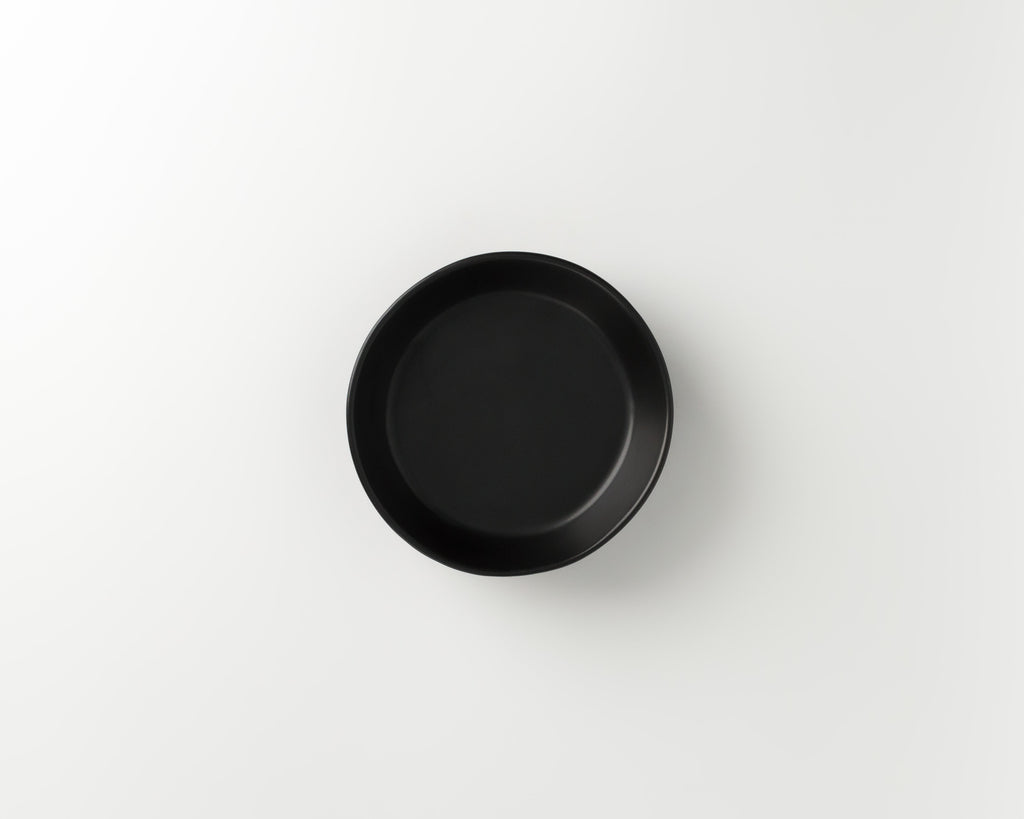 Black round dish on a white background