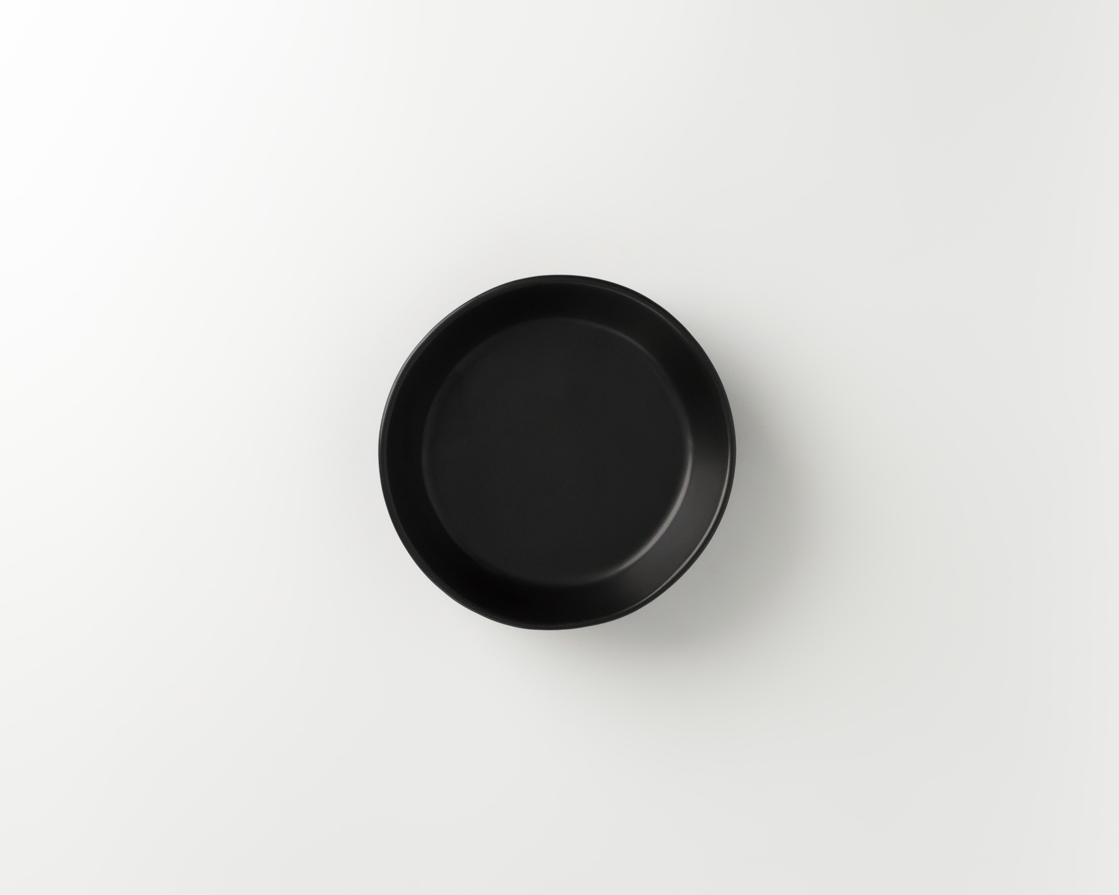 Black round dish on a white background