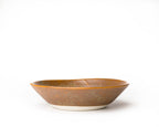 Ceramic bowl with brown glaze on a white background