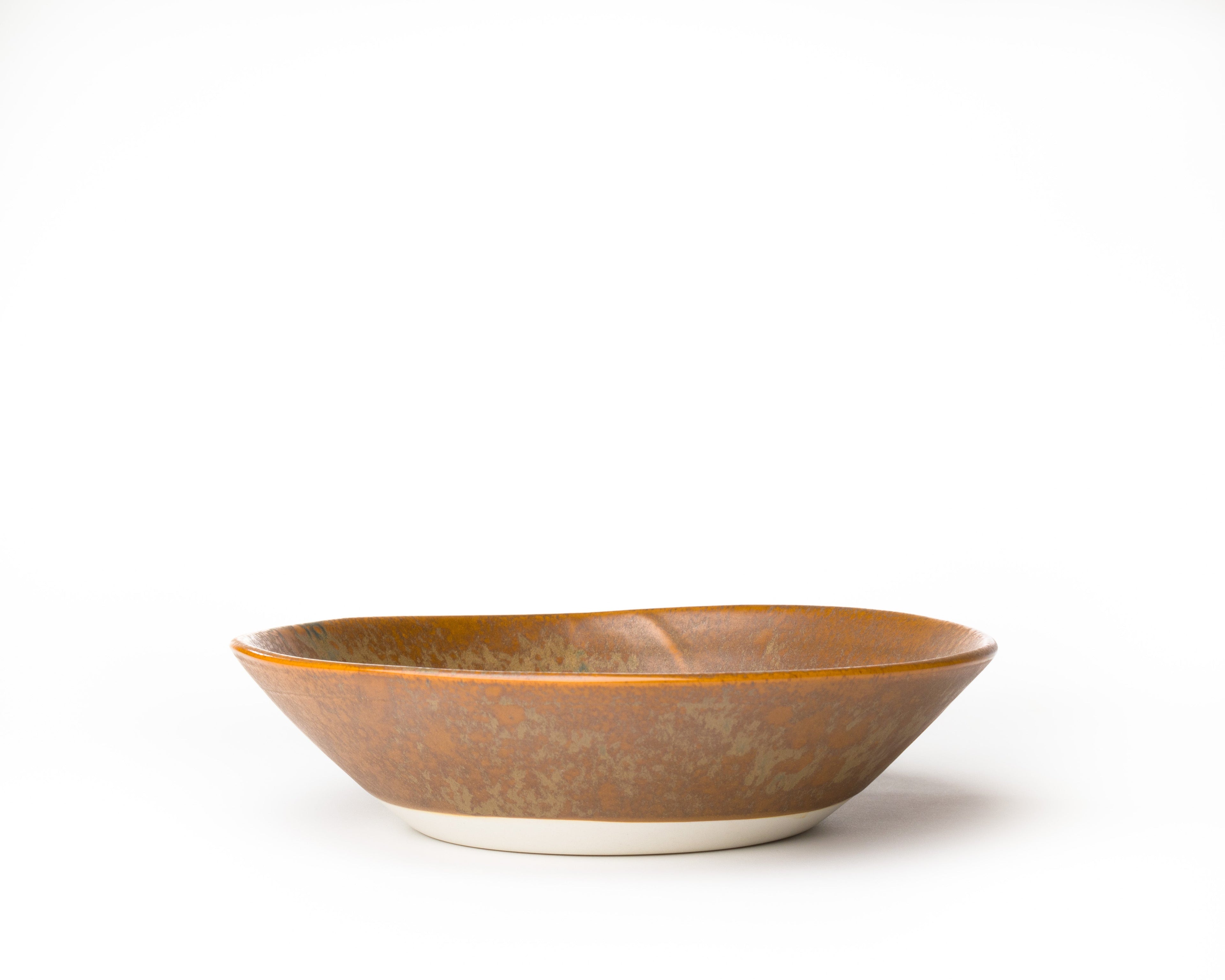 Ceramic bowl with brown glaze on a white background