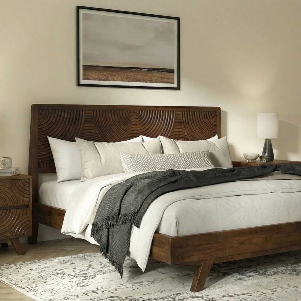 Wooden bed with white bedding and decorative pillows in a bedroom setting.