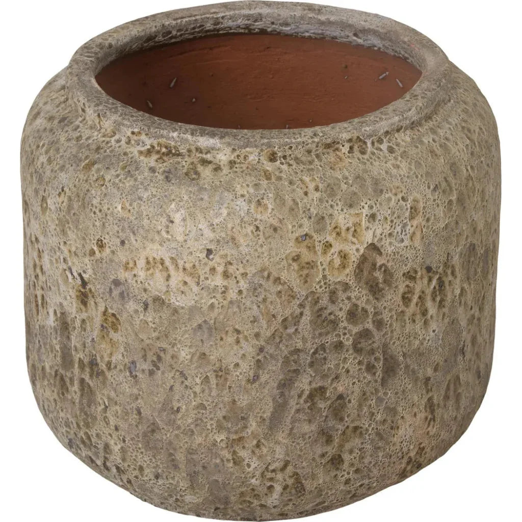 Textured stone pot with a terracotta interior on a white background