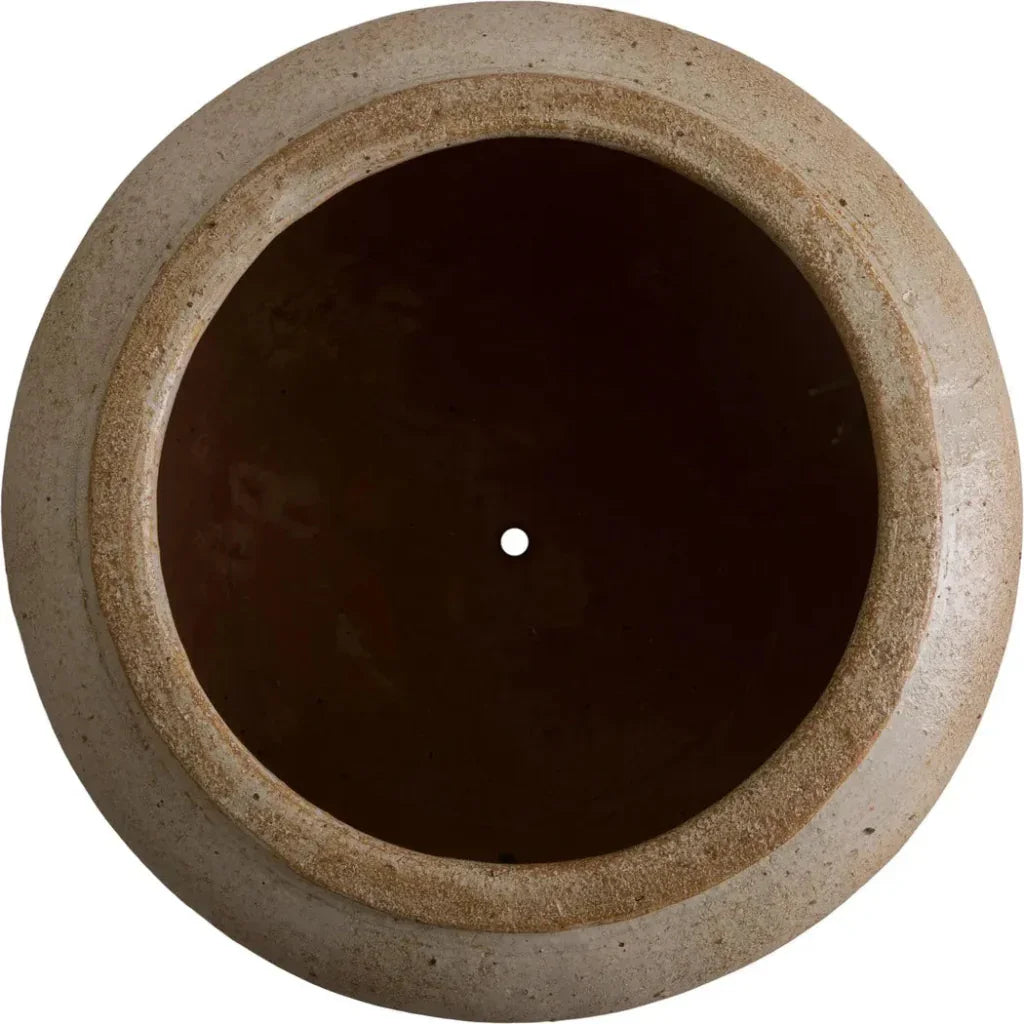 Round stone-like object with a dark center on a white background