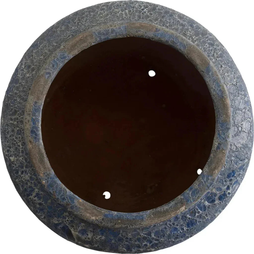 Round stone-like object with a dark center on a white background
