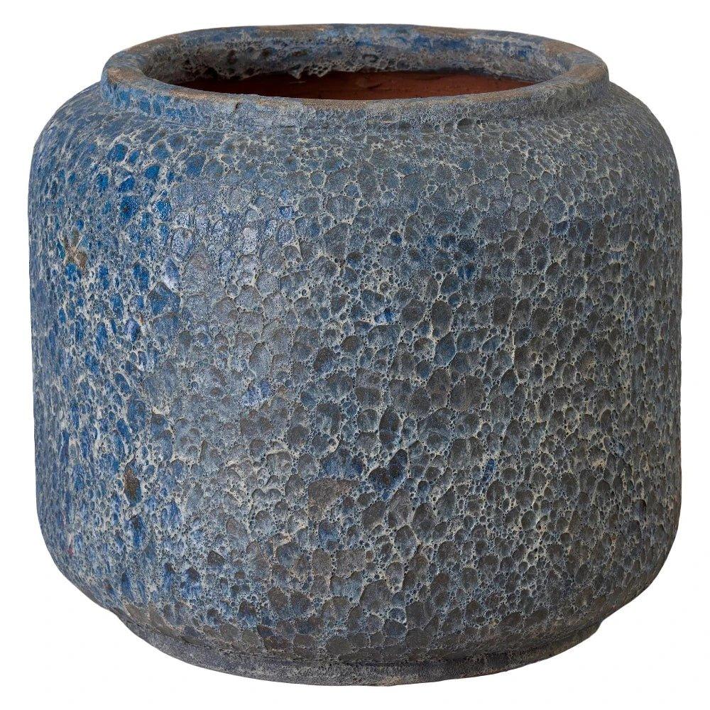 Textured blue ceramic pot on a white background