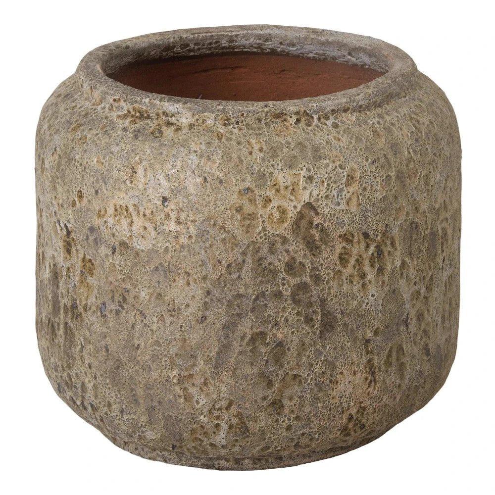 Textured stone-like pot on a white background