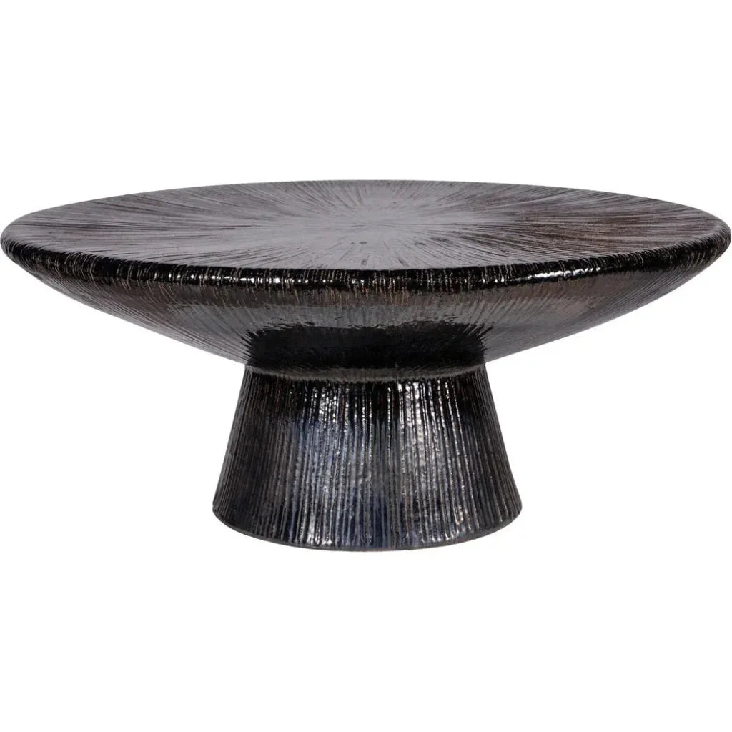 Round black textured table on a white background