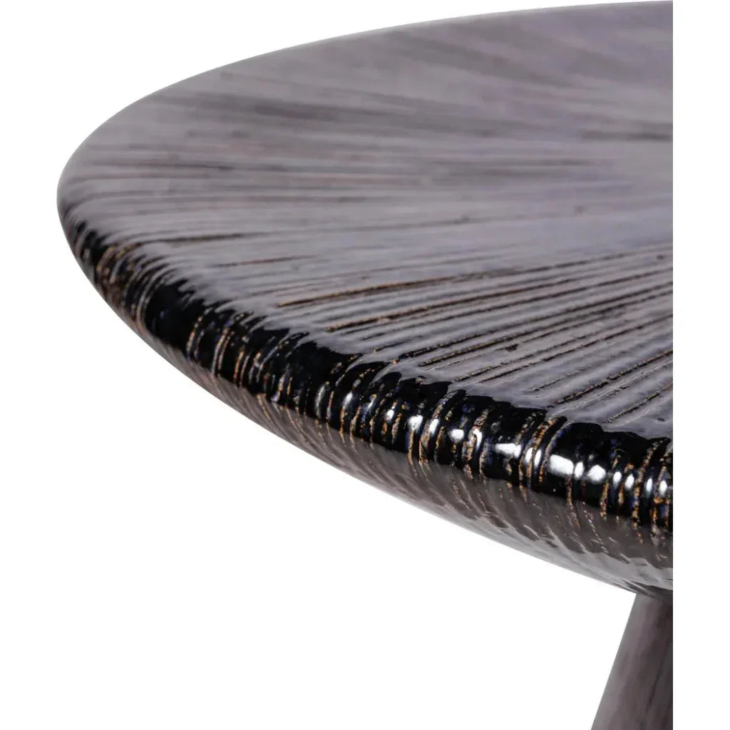 Close-up of a round wooden table with a textured surface on a white background