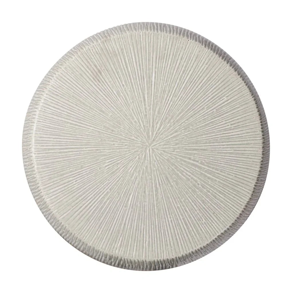 Round textured stool with a starburst pattern on a white background