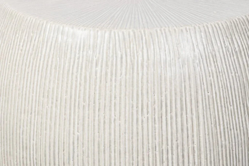 Close-up of a textured white stool surface